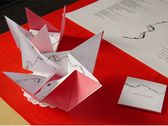 Image of folded origami CD cover on red table cloth